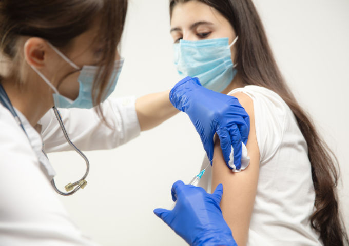 Adolescent receiving a vaccine