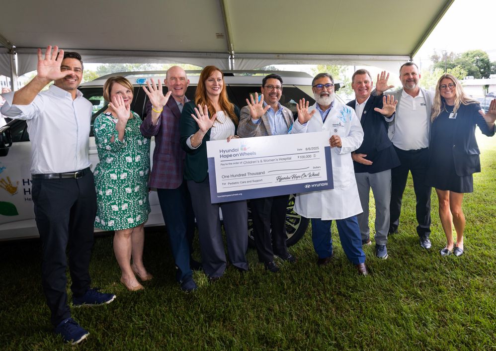 Members of USA Health leadership stand with representatives from Hyundai Hope on Wheels