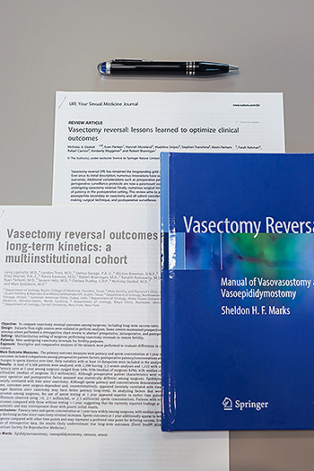 A textbook and articles about vasectomy reversal procedures.