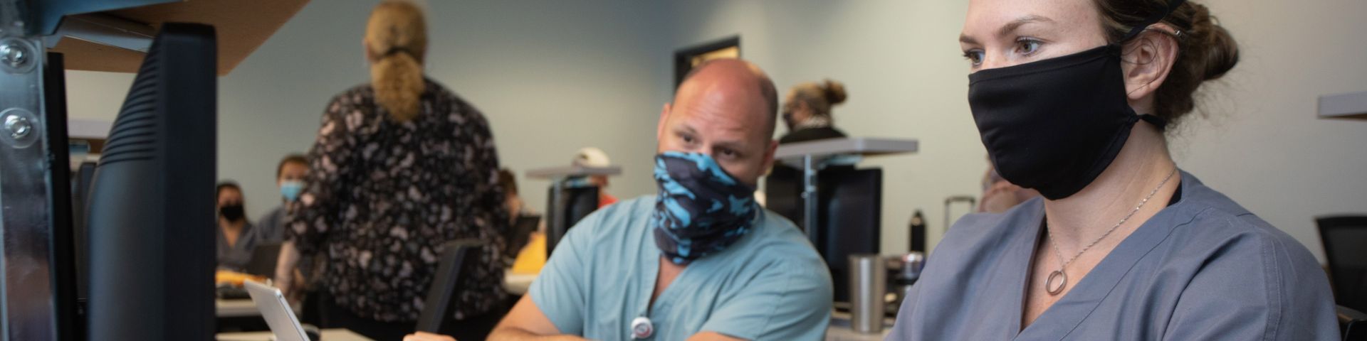 People taking a computer-based training at USA Health