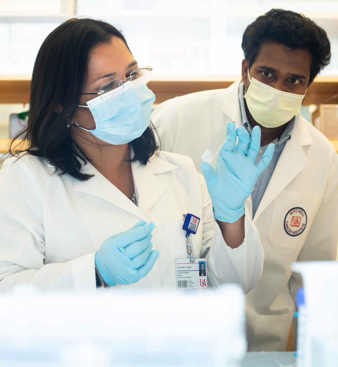 Chandrani Sarkar, Ph.D., and Sooraj Kakkat, Ph.D., work in the lab at the Mitchell Cancer Institute.