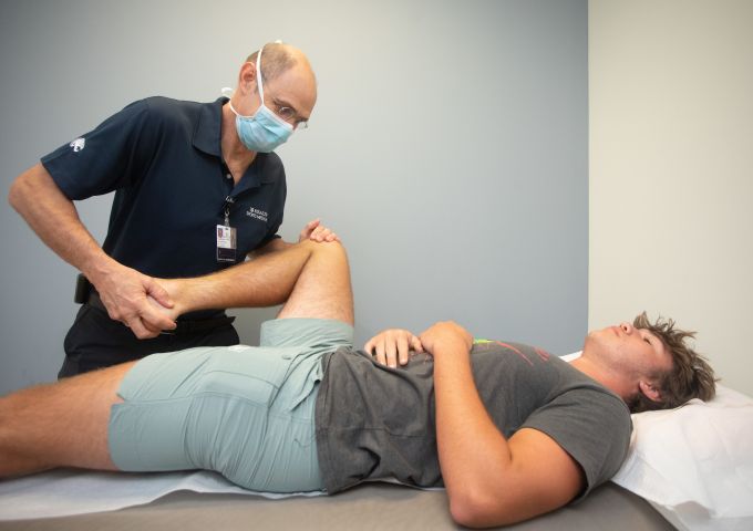 Dr. James Slauterbeck performs a physical for a MCPSS student in July 2022.