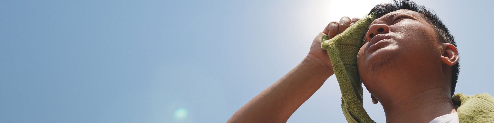 A man stands outside in the heat